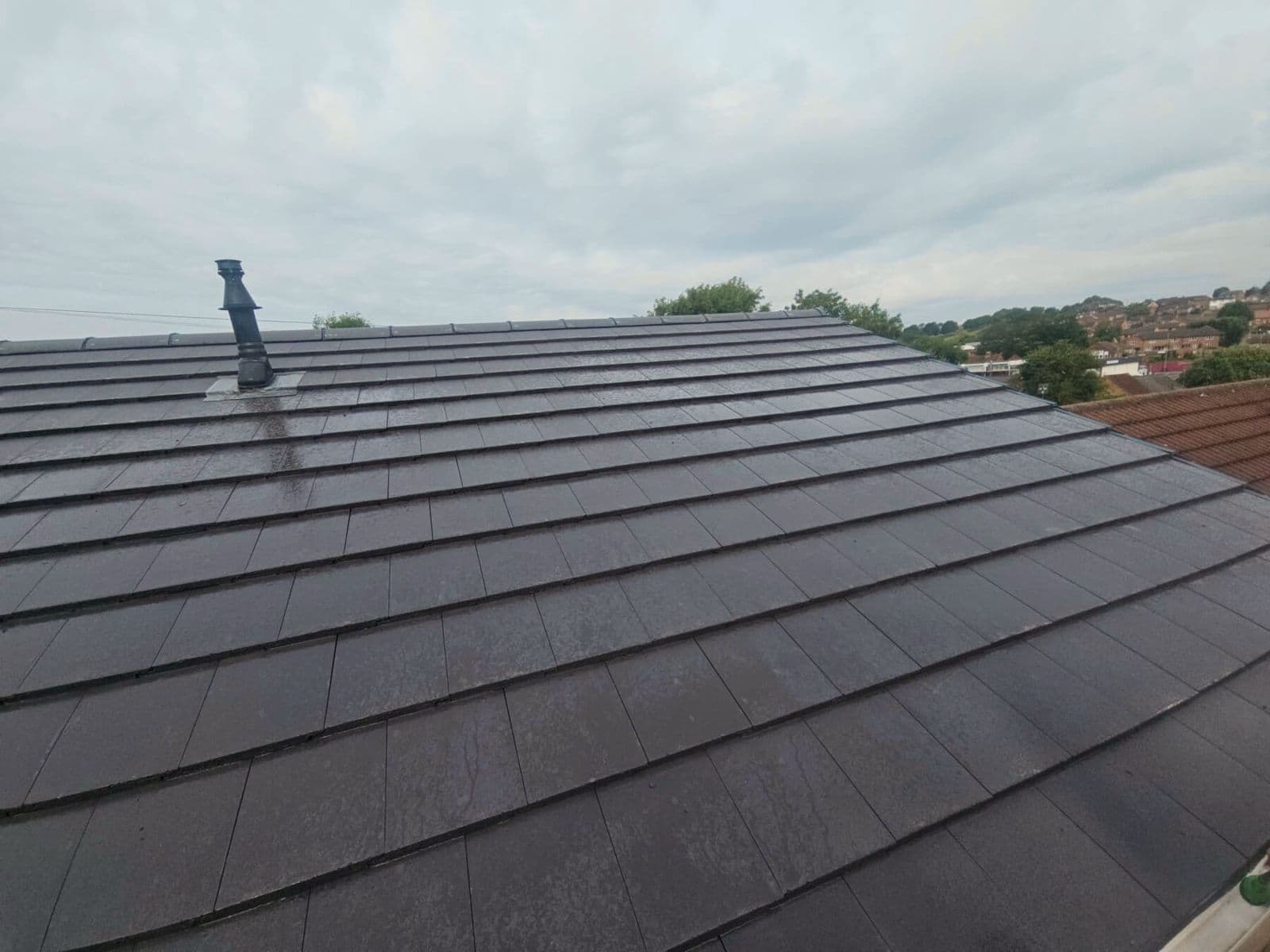 The same roof finished in new grey tile