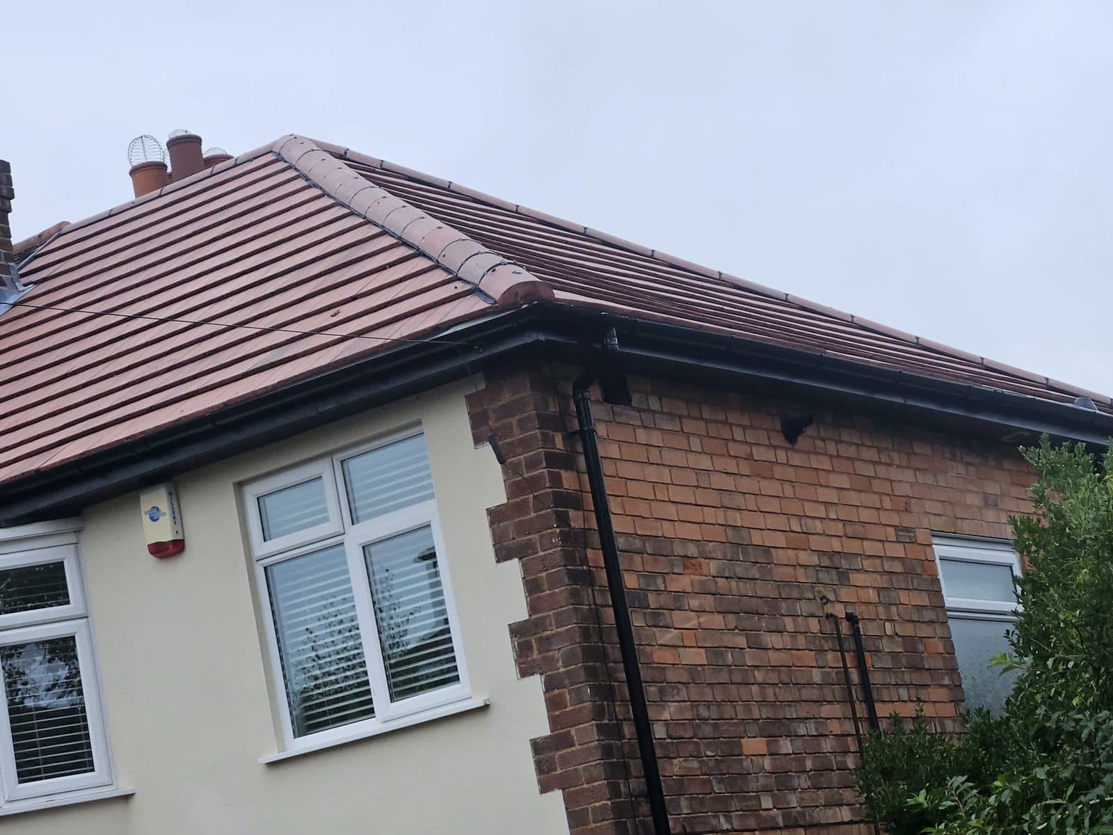 The same plain tile roof from the corner, showing the hip tiles