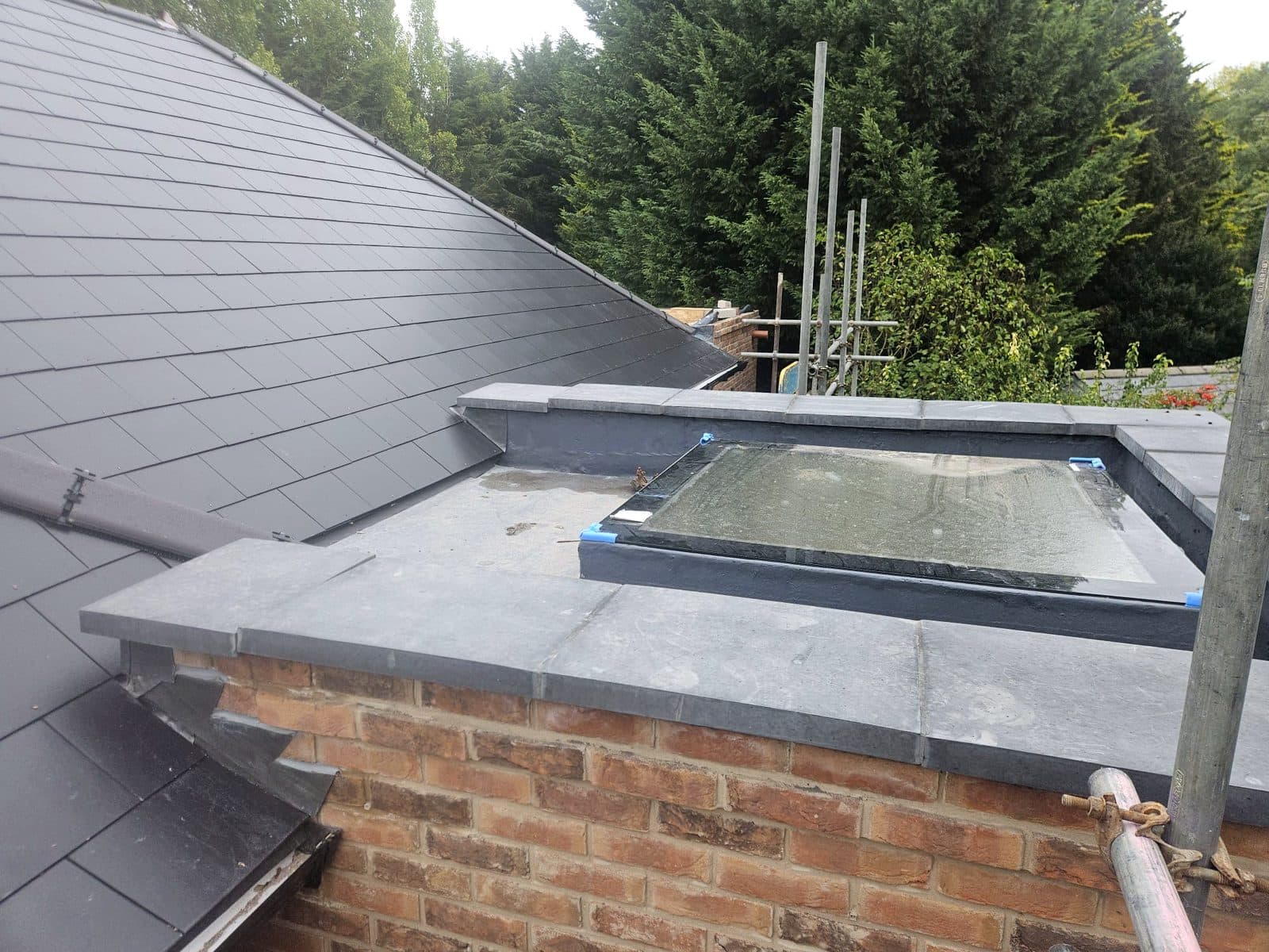 The new flat roof behind the parapet, with a rooflight fitted and new coping on the wall