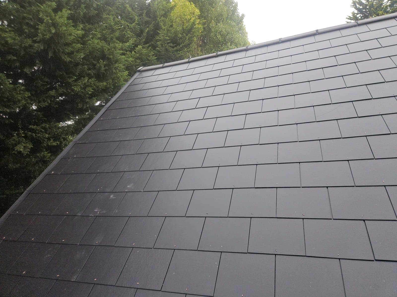 A finished slate slope with the trees behind