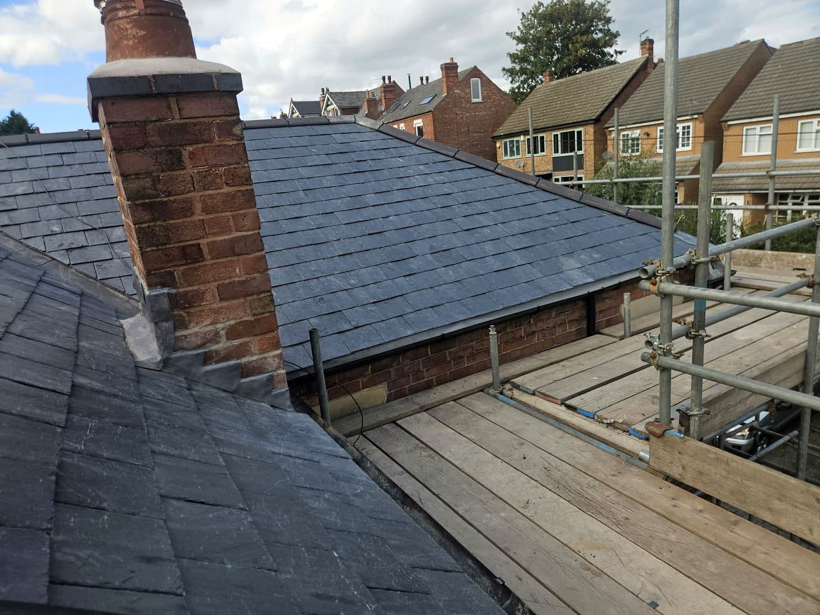 New stepped lead flashing dressed around the chimney stack on the slate roof