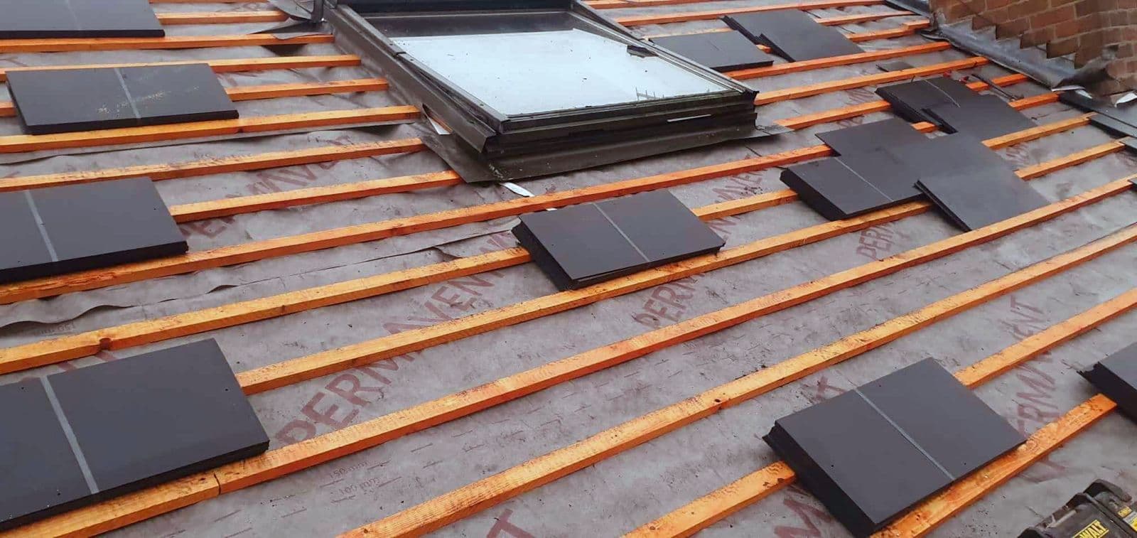 Insulation boards being laid on a flat roof before the covering goes down