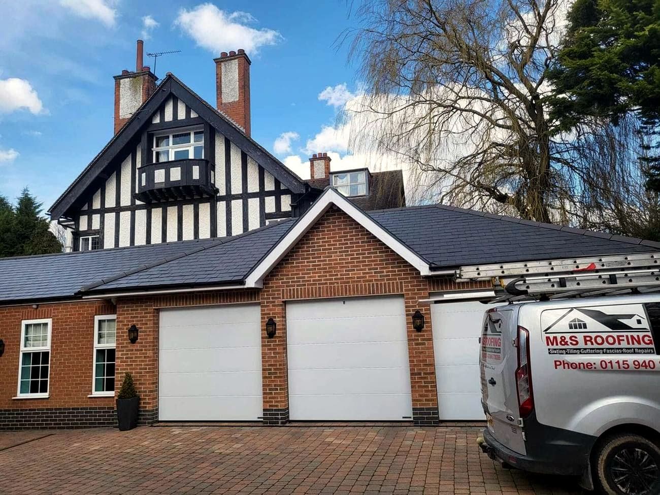 A Nottingham house with a newly slated garage roof and an M&S Roofing van on the drive