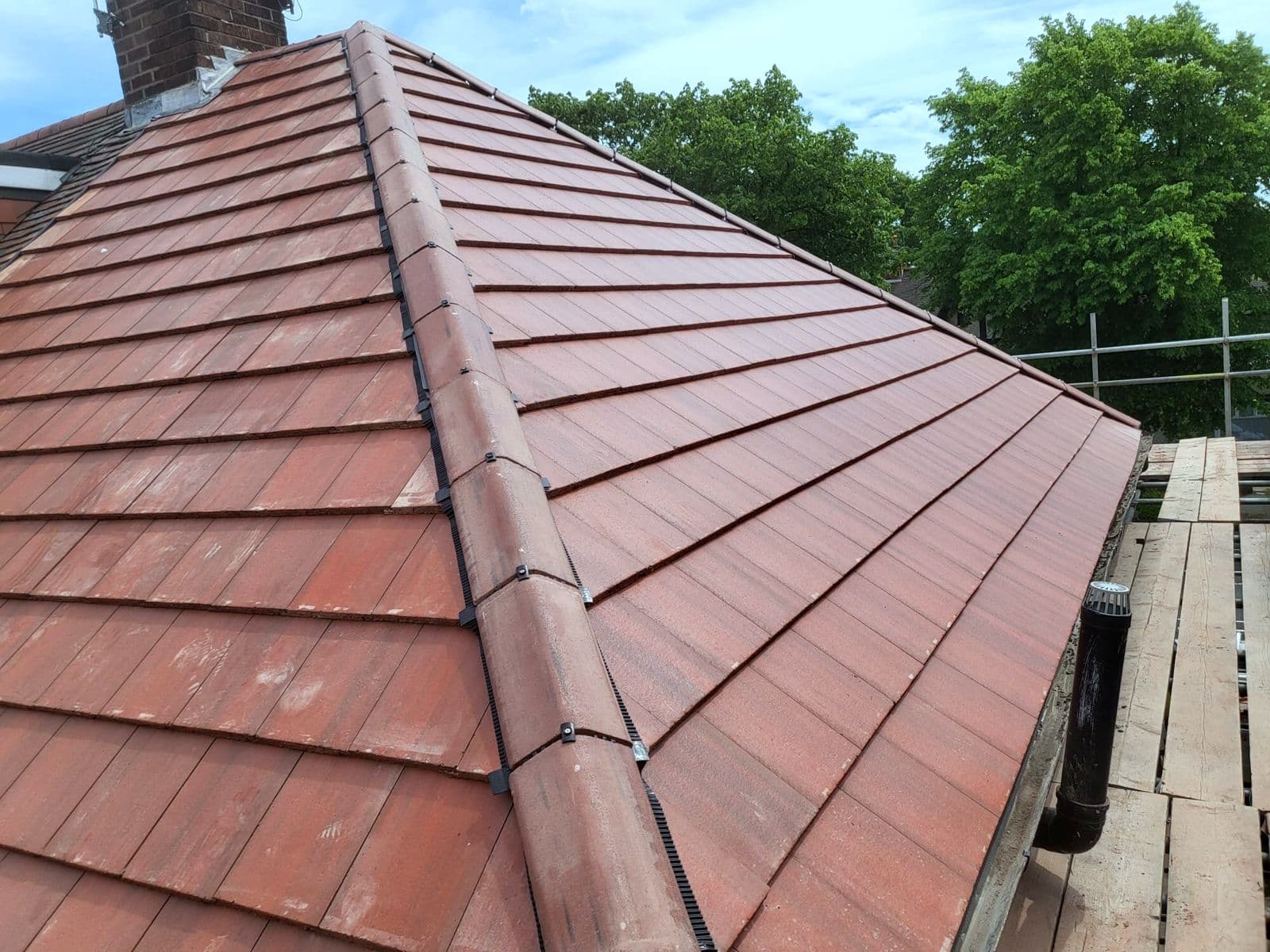 Red clay hip and ridge tiles on the finished roof