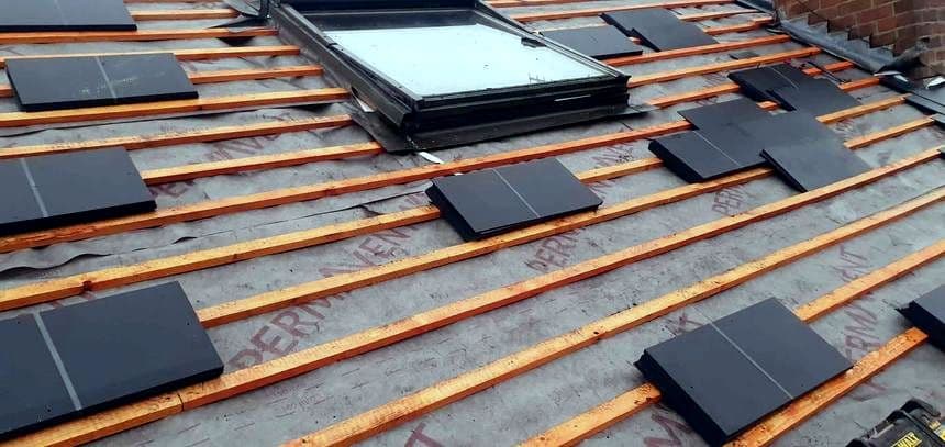 Slates being laid over battens